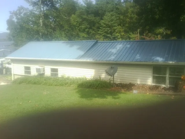 Blue metal roof running the length of a single story home in Gwynn